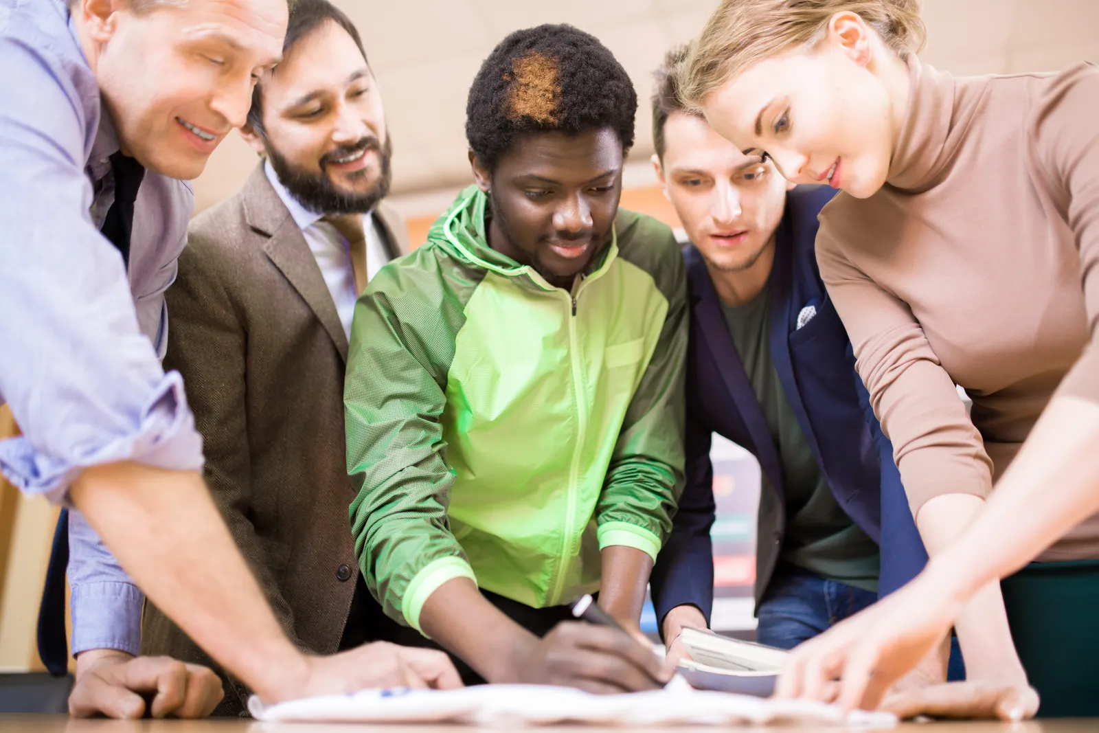 Colleagues collaborating over documents during a workplace training session