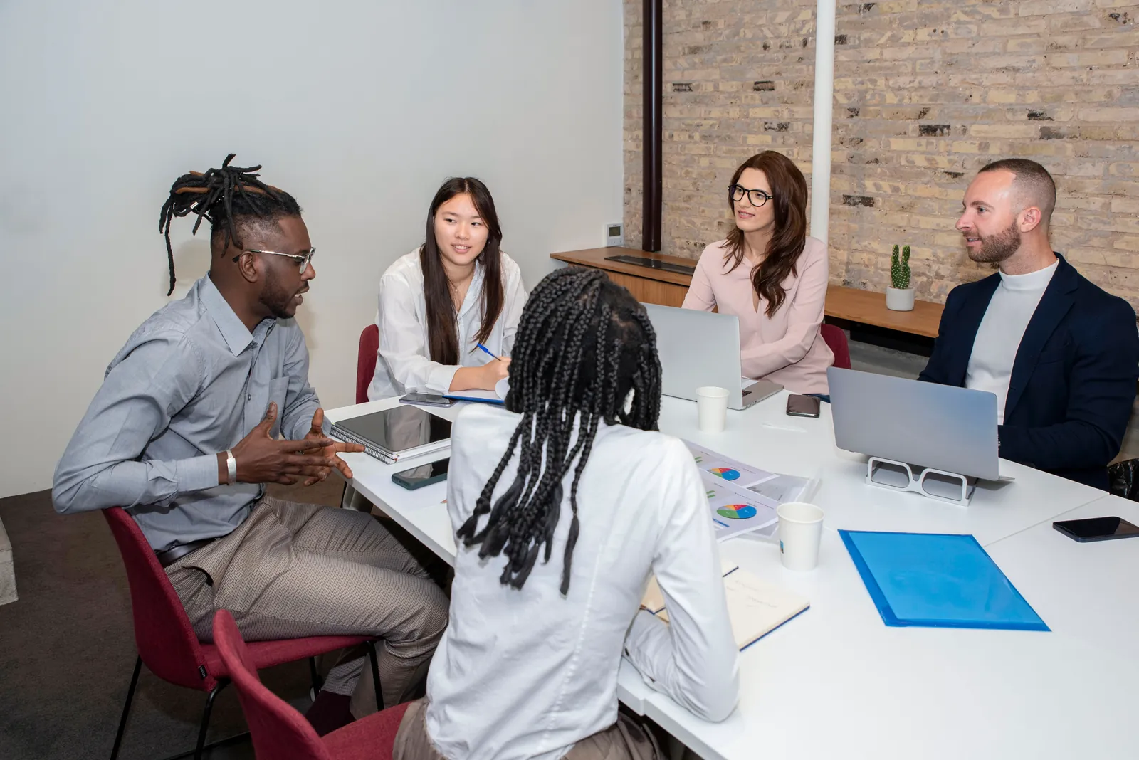 Partners in discussion around a meeting table